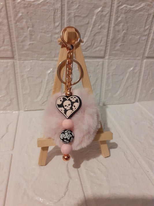 rose gold pink skeleton keychain with pale pink pompom